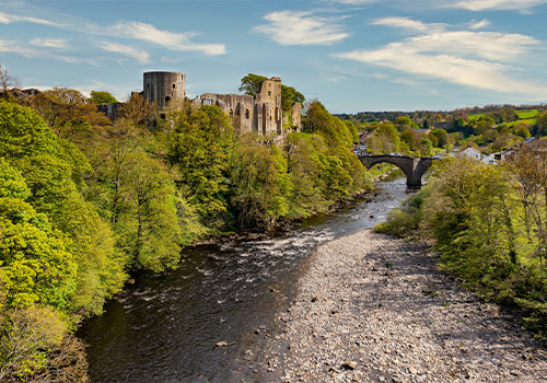 View of Barnard Castle and stone bridge over river